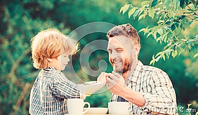 Super father. organic and natural food. small boy child with dad. father and son eat outdoor. healthy food. Family day Stock Photo
