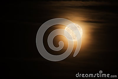 Super full moon known as a supermoon with soft clouds Stock Photo