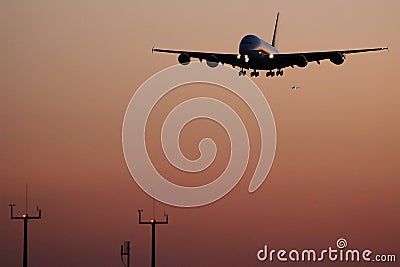 Super jumbo, plane landing at sunset Stock Photo