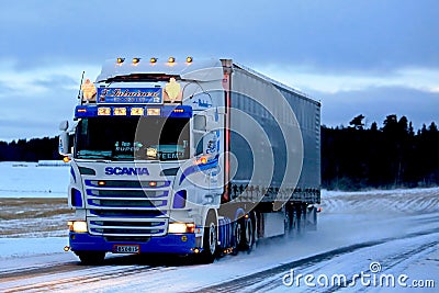 Super Scania Semi on Snowy Road at Sunset Editorial Stock Photo