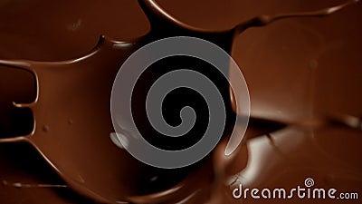Super slow motion di pezzi di cioccolato crudi che si spruzzano in cioccolato fuso stock footage Super slow motion di pezzi di cioccolato crudi che si spruzzano in cioccolato fuso stock footage