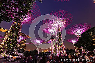 Super tree light glowing Singapore landmark Gardens by the Bay and Marina Bay Sands building with sunset twilight sky background Editorial Stock Photo