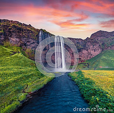 Superb summer sunrise on Seljalandsfoss watterfall. Stock Photo