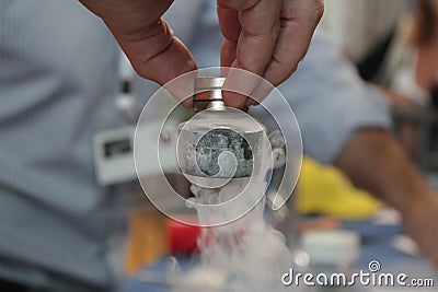 Superconductor levitating under magnets Stock Photo