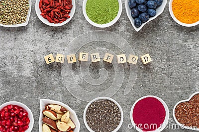 Superfood as acai powder, turmeric, matcha green tea, pumpkin, chia seeds, blueberry, goji, hemp, pomegranate seeds Stock Photo