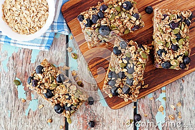 Superfood breakfast bars on wood board, above scene Stock Photo