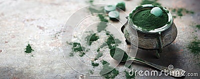 Superfood concept ground green spirulina algae powder, pills tablets Stock Photo