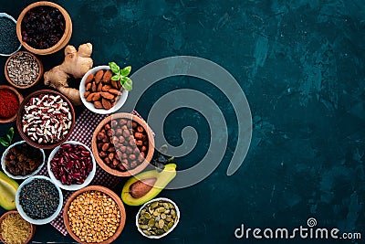 Superfoods Healthy food. Nuts, berries, fruits, and legumes. On a black stone background. Stock Photo