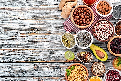 Superfoods Healthy food. Nuts, berries, fruits, and legumes. On a white wooden background. Stock Photo