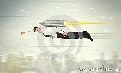 Superhero business man flying with jet pack rocket above the cit Stock Photo