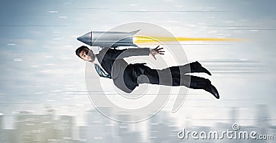 Superhero business man flying with jet pack rocket above the cit Stock Photo