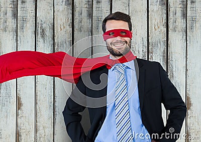 Superhero businessman against wood Stock Photo