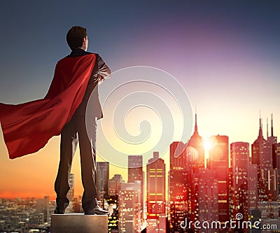 Superhero businessman looking at city Stock Photo