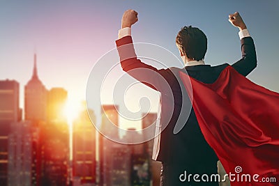 Superhero businessman looking at city Stock Photo