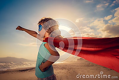 Superhero child on the beach. Summer vacation concept Stock Photo