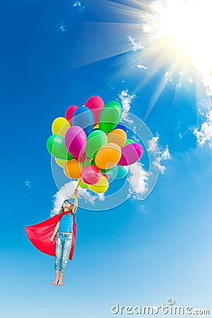 Superhero child playing with bright multicolor balloons Stock Photo