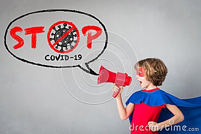 Superhero child speaking by loudspeaker about COVID-19 Stock Photo