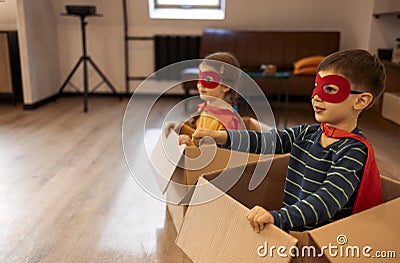 Superhero children. Super hero kids, brother and sister, playing at home Stock Photo