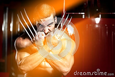 Superhero With Claws Flexing Muscles in Fitness center Editorial Stock Photo