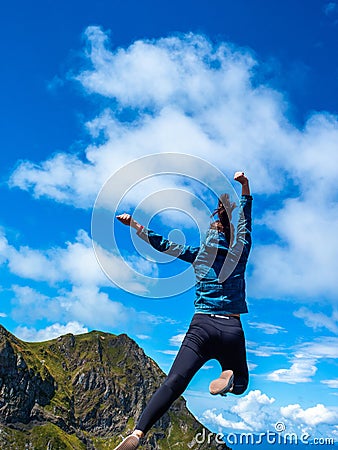 Superhero jump in the mountains against the sky. Ambition and purpose, concept. Stock Photo