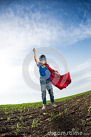 Superhero kid jumping Stock Photo