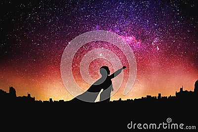 Superhero silhouette at the night starry sky background Stock Photo