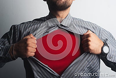 Superhero tears his shirt. red super suit under his clothes Stock Photo