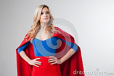 Superhero Woman. Young and beautiful blonde in image of superheroine in red Cape growing Stock Photo