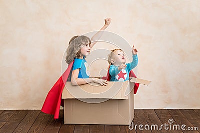 Superheroes children playing in cardboard box Stock Photo