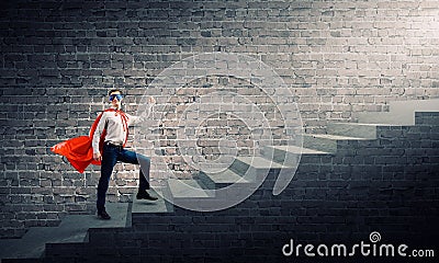 Superman on ladder Stock Photo