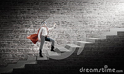 Superman on ladder Stock Photo