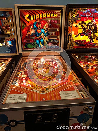 Superman pinball machine between Stern Pinball and Williams` Black Knight. Editorial Stock Photo