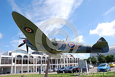 Supermarine Spitfire fighter on display. Clouds and blue sky on background Editorial Stock Photo