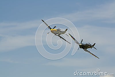 A Supermarine Spitfire and North American P-51 Mustang flying in tandem Editorial Stock Photo