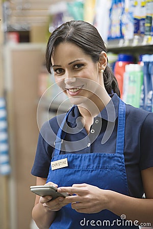 Supermarket Employee In Blue Apron Stock Photo