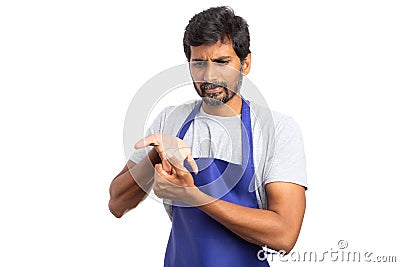 Supermarket employee checking injured wrist Stock Photo