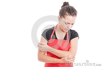Supermarket employee having elbow medical problem Stock Photo