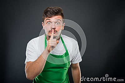 Supermarket employer posing showing silence gesture Stock Photo