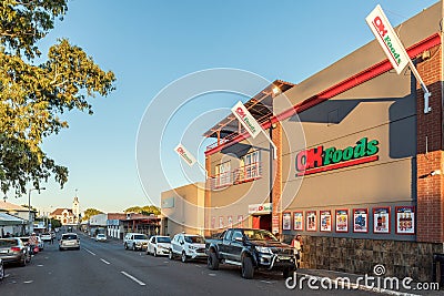 Supermarket, people, vehicles and church, in Prieska Editorial Stock Photo