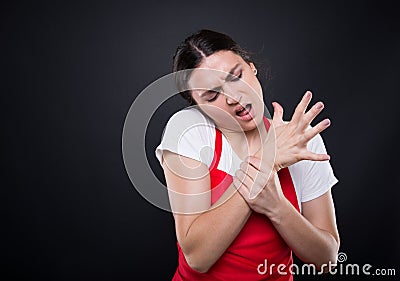 Supermarket seller suffering from wrist pain Stock Photo