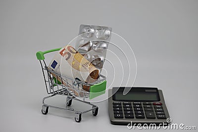 A supermarket trolley full of blister pills, a lot of pills in a wheelbarrow. Concept: home delivery of medicines.Empty Stock Photo