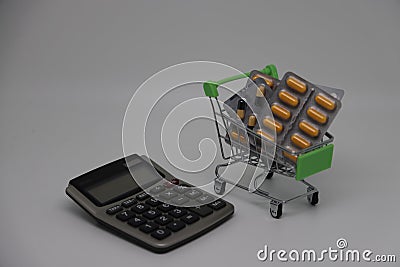 A supermarket trolley full of blister pills, a lot of pills in a wheelbarrow. Concept: home delivery of medicines.Empty Stock Photo