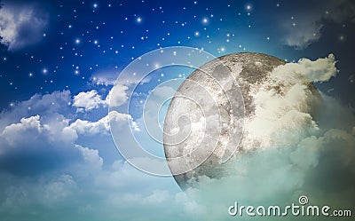 Supermoon in the night sky and stars hidden behind the clouds with a wonderful night with the concept of nature and romance Stock Photo