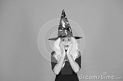 Supernatural charmer gray hair. kid enchantress orange background. happy halloween. magic fantasy. scared small girl Stock Photo
