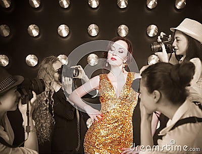 Superstar woman posing to paparazzi Stock Photo