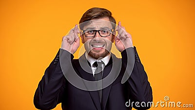 Superstitious businessman crossing fingers for good luck, hoping to win, fortune Stock Photo