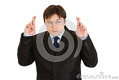 Superstitious businessman holding crossed fingers Stock Photo