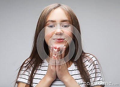 Superstitious teenager girl hoping her wishes will come true, having excited happy look Stock Photo