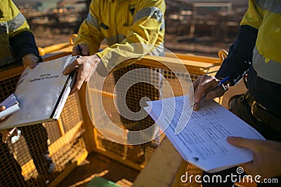 Supervisor checking before sigh of working at height permit JSA risk assessment on site prior to performing high risk work Stock Photo