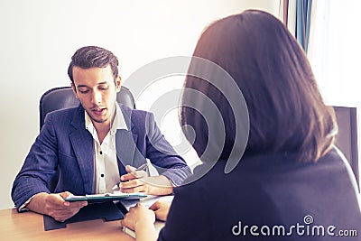 Supervisor explaining documents contractto a female worker Stock Photo